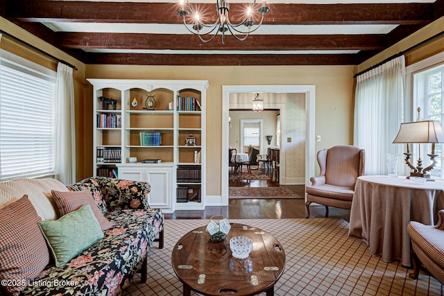 916 Audubon Pkwy, Audubon Park, KY 40213 - living room with beam ceiling, a chandelier, wood finished floors, and baseboards