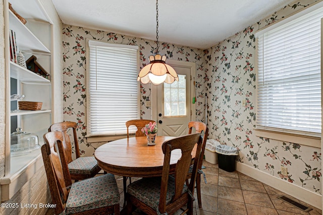 916 Audubon Pkwy, Audubon Park, KY 40213 - dining room with wallpapered walls and baseboards