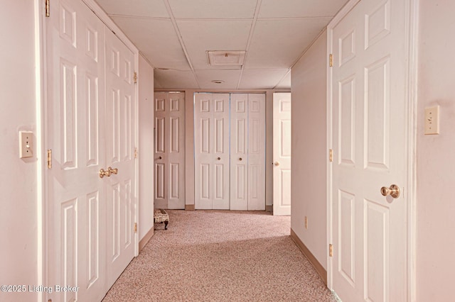 916 Audubon Pkwy, Audubon Park, KY 40213 - hallway featuring a paneled ceiling, carpet flooring, and baseboards
