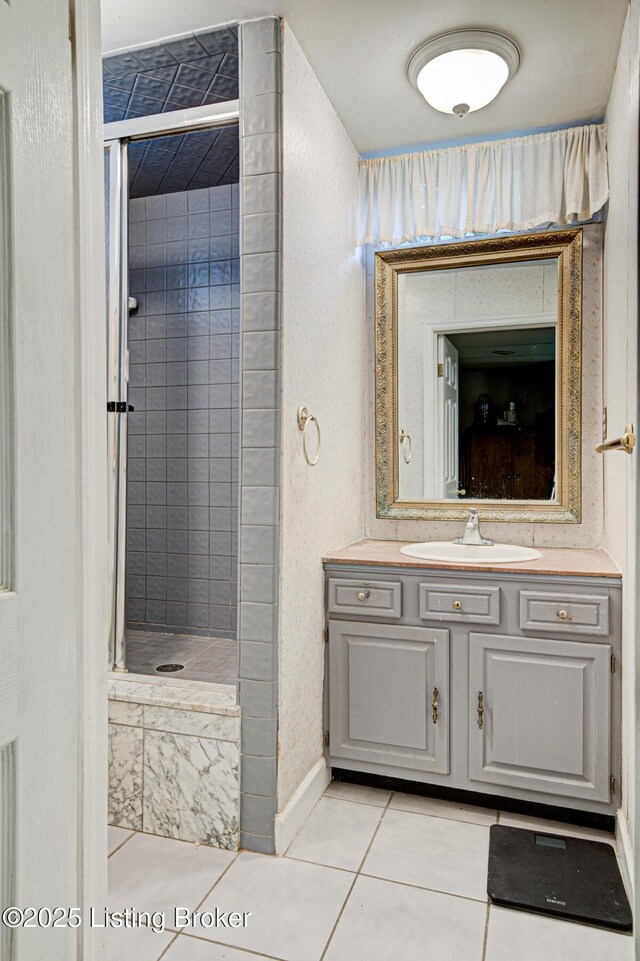 916 Audubon Pkwy, Audubon Park, KY 40213 - bathroom featuring tile patterned flooring, a stall shower, vanity, and baseboards