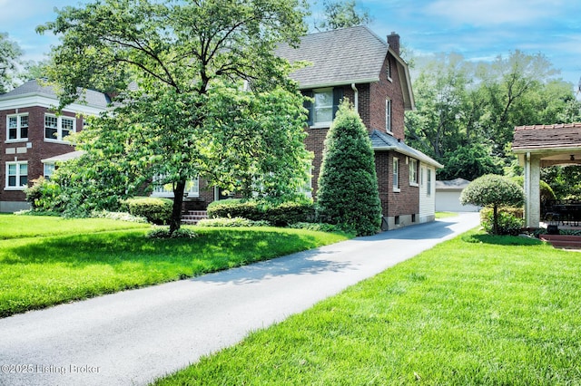 916 Audubon Pkwy, Audubon Park, KY 40213 - view of front of house with brick siding, a chimney, and a front lawn