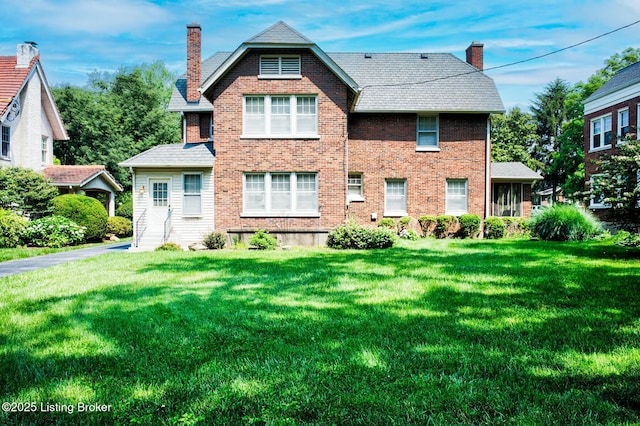 916 Audubon Pkwy, Audubon Park, KY 40213 - view of front facade featuring a chimney, a front yard, and brick siding