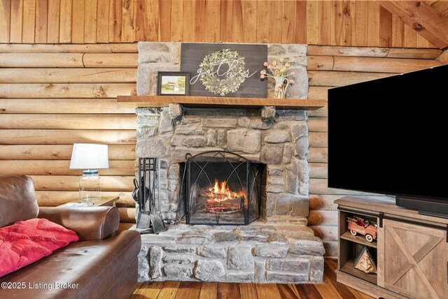 3804 Grassy Creek Dr, Lexington, KY 40503 - living room featuring log walls, a stone fireplace, and wood finished floors