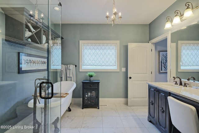 5201 Spring Mist Ct, Prospect, KY 40059 - full bath featuring marble look tiles, a freestanding bath, vanity, a chandelier, and baseboards