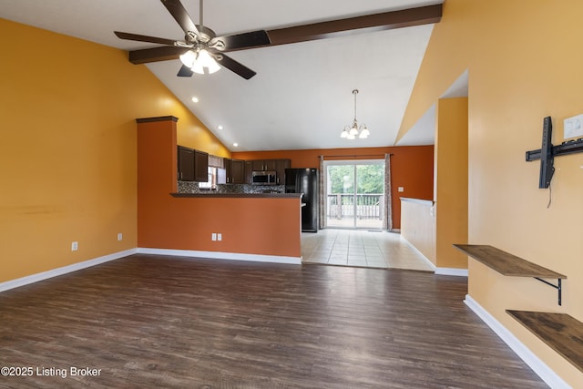 6821 James Madison Way, Louisville, KY 40272 - kitchen with stainless steel microwave, freestanding refrigerator, open floor plan, beam ceiling, and a chandelier