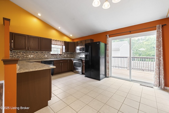 6821 James Madison Way, Louisville, KY 40272 - kitchen featuring stainless steel appliances, vaulted ceiling, decorative backsplash, light tile patterned flooring, and a sink