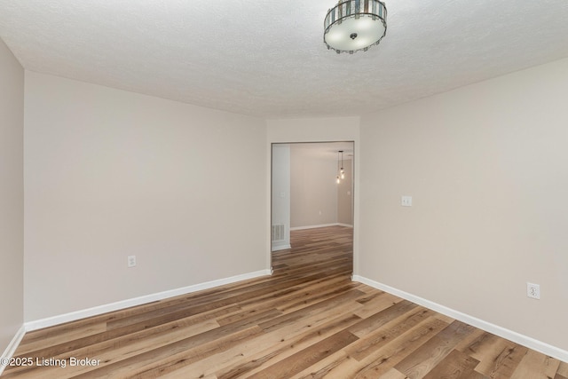 10304 Southern Meadows Dr Unit 101, Louisville, KY 40241 - spare room with light wood-style flooring, baseboards, and a textured ceiling