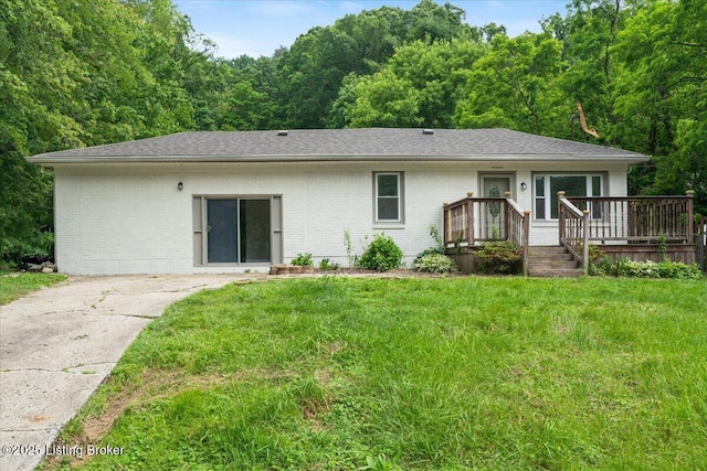 10711 Jefferson Hill Rd, Fairdale, KY 40118 - back of property featuring brick siding, a lawn, and a view of trees