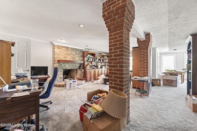 2309 Phoenix Hill Dr, Louisville, KY 40207 - office area with carpet floors, a textured ceiling, crown molding, a stone fireplace, and decorative columns