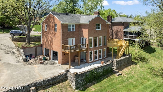 2309 Phoenix Hill Dr, Louisville, KY 40207 - back of property with concrete driveway, a chimney, a patio, an attached garage, and a deck