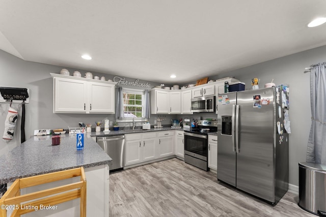 987 Wheelers Mill Rd, Munfordville, KY 42765 - kitchen featuring appliances with stainless steel finishes, a peninsula, a sink, white cabinets, and recessed lighting