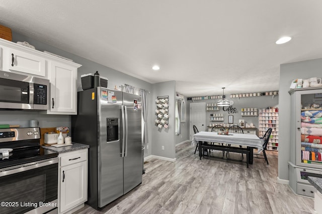 987 Wheelers Mill Rd, Munfordville, KY 42765 - kitchen with appliances with stainless steel finishes, white cabinetry, baseboards, light wood-style flooring, and recessed lighting