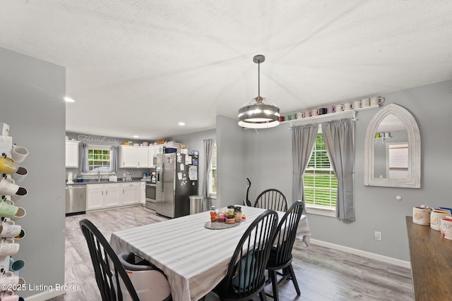 987 Wheelers Mill Rd, Munfordville, KY 42765 - dining room featuring light wood-type flooring, baseboards, recessed lighting, and a textured ceiling
