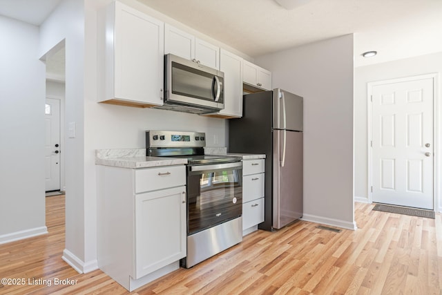 10518 Fairview Ave, Louisville, KY 40299 - kitchen with appliances with stainless steel finishes, light wood-type flooring, white cabinets, and baseboards