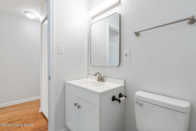 10518 Fairview Ave, Louisville, KY 40299 - bathroom with vanity, wood finished floors, toilet, and baseboards