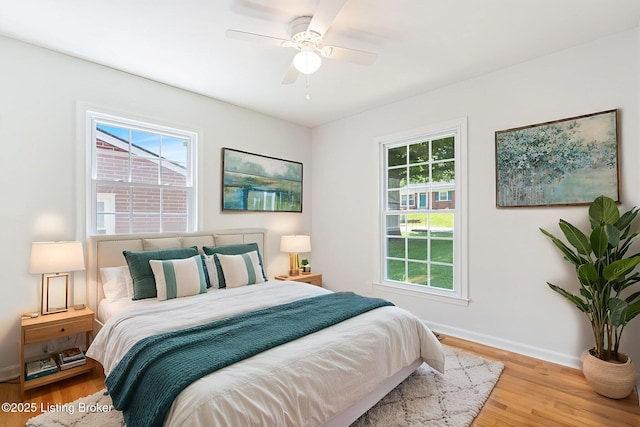 10518 Fairview Ave, Louisville, KY 40299 - bedroom with multiple windows, wood finished floors, and baseboards