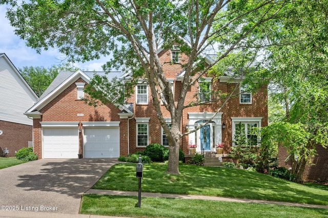 3613 Wynbrooke Cir, Louisville, KY 40241 - view of front of house with asphalt driveway, a garage, and brick siding
