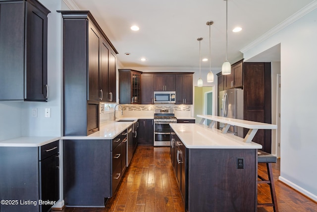 3613 Wynbrooke Cir, Louisville, KY 40241 - kitchen featuring appliances with stainless steel finishes, a breakfast bar, dark wood finished floors, backsplash, and a sink