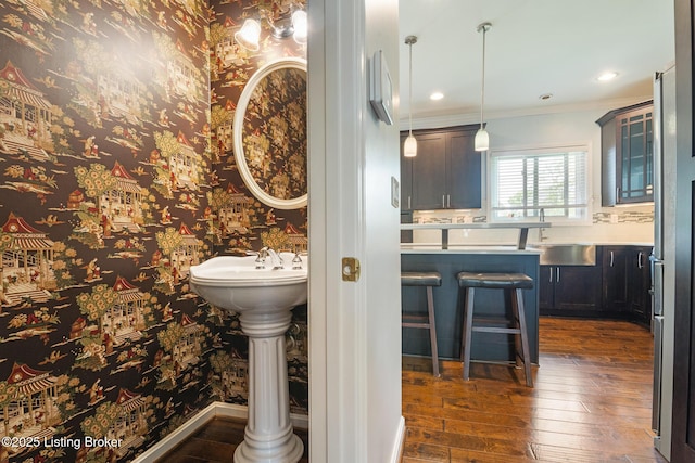 3613 Wynbrooke Cir, Louisville, KY 40241 - bathroom featuring wood-type flooring, ornamental molding, a sink, and wallpapered walls