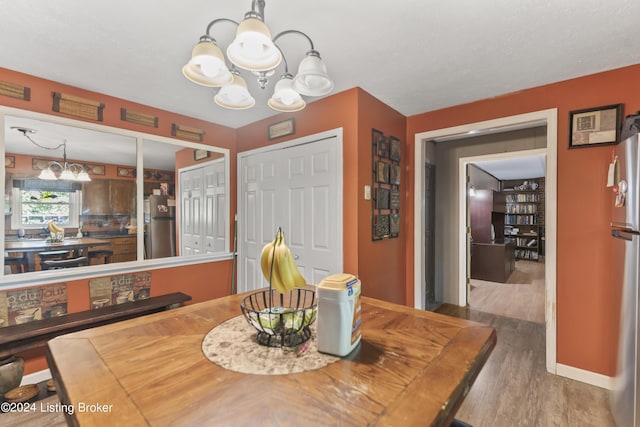 140 Ample Way, Shepherdsville, KY 40229 - dining area with a chandelier, wood finished floors, and baseboards
