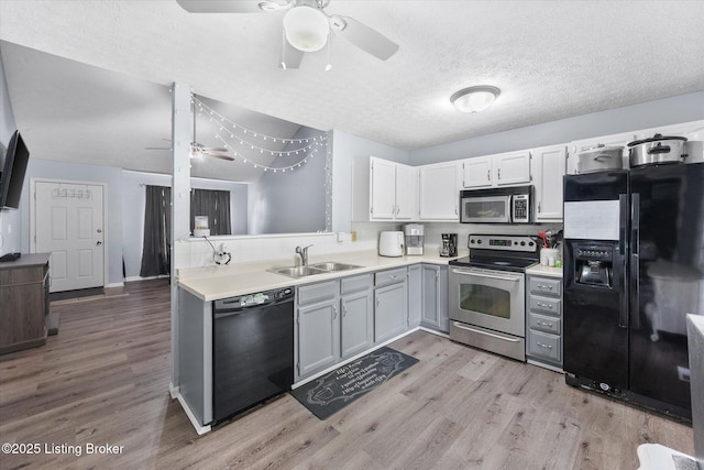 1300 Keane Ave, La Grange, KY 40031 - kitchen with black appliances, a sink, a ceiling fan, light wood-style floors, and light countertops