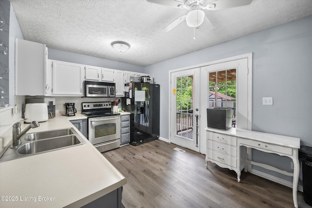 1300 Keane Ave, La Grange, KY 40031 - kitchen with stainless steel appliances, a sink, wood finished floors, french doors, and light countertops