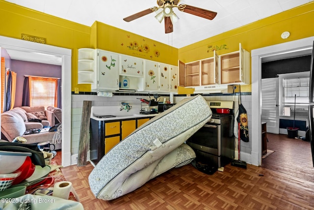 2028 S 16th St, Louisville, KY 40210 - kitchen with open shelves, stainless steel range, a ceiling fan, under cabinet range hood, and white cabinetry
