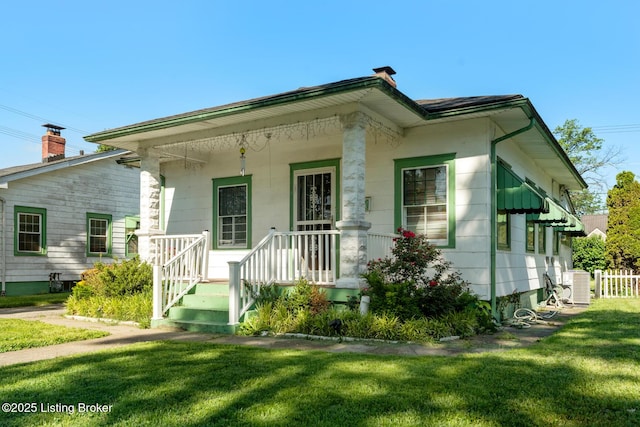 2028 S 16th St, Louisville, KY 40210 - view of front of home featuring a front yard, cooling unit, and covered porch