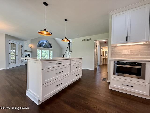 5101 Elm Tree Pl, Louisville, KY 40299 - kitchen with dark wood-type flooring, baseboards, oven, pendant lighting, and light countertops
