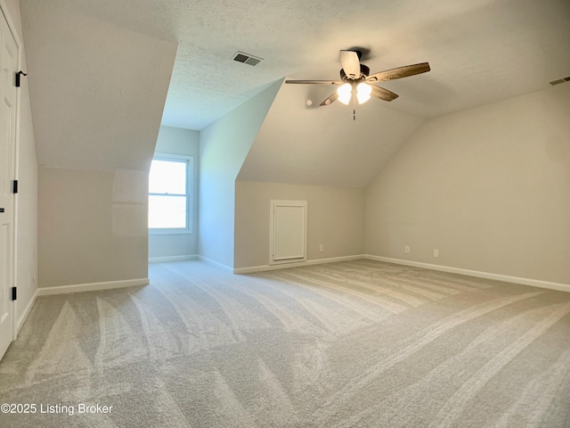 5101 Elm Tree Pl, Louisville, KY 40299 - bonus room with a ceiling fan, baseboards, lofted ceiling, light colored carpet, and a textured ceiling