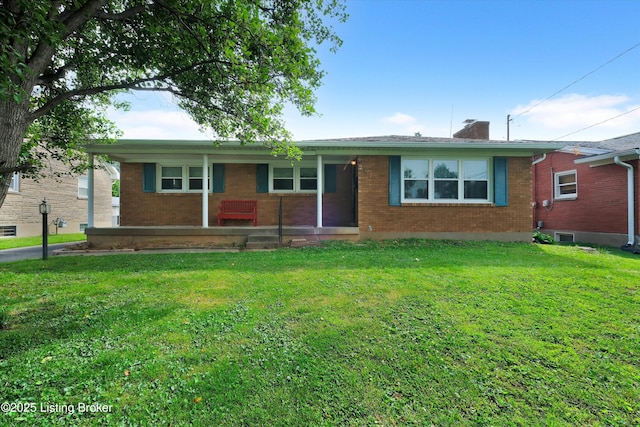 2717 Delor Ave, Louisville, KY 40217 - single story home featuring brick siding, a front yard, and a chimney