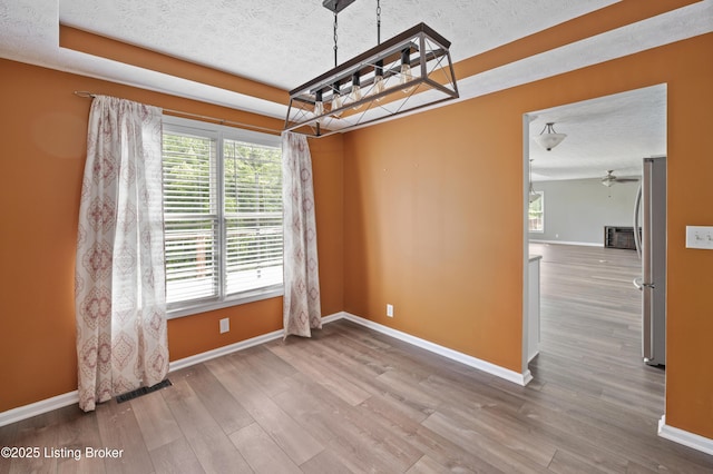 12308 Dominion Way, Louisville, KY 40299 - unfurnished dining area with baseboards, a textured ceiling, wood finished floors, and a ceiling fan