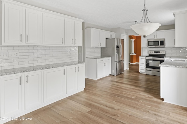 12308 Dominion Way, Louisville, KY 40299 - kitchen with appliances with stainless steel finishes, a sink, backsplash, and white cabinets