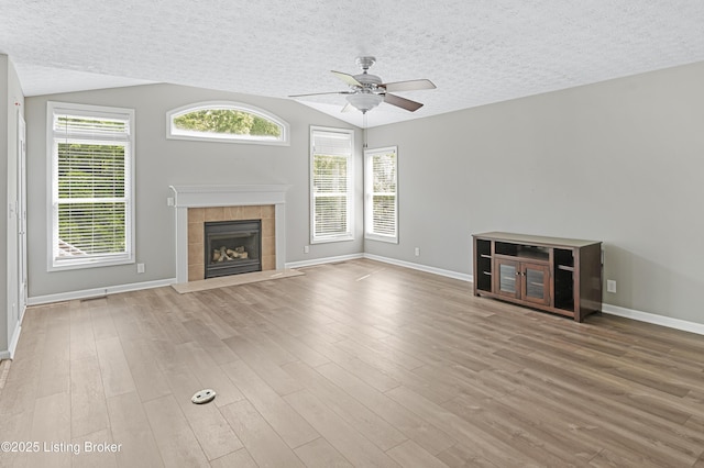 12308 Dominion Way, Louisville, KY 40299 - unfurnished living room featuring a ceiling fan, a textured ceiling, baseboards, wood finished floors, and a tile fireplace