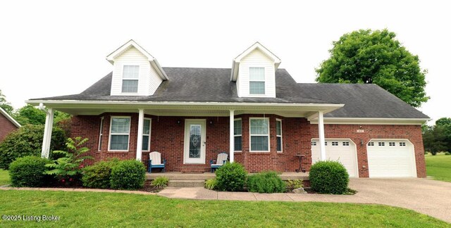 42 Rolling Ridge Ct, Brandenburg, KY 40108 - cape cod house featuring brick siding, driveway, a front lawn, and a garage