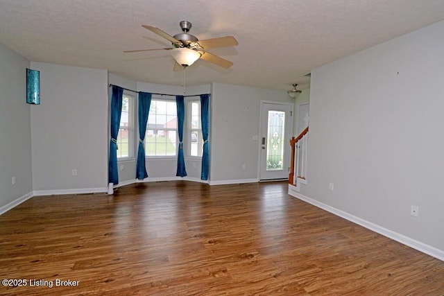 42 Rolling Ridge Ct, Brandenburg, KY 40108 - unfurnished room featuring wood finished floors, a ceiling fan, baseboards, and stairway
