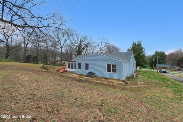 8400 Wisertown Rd, Louisville, KY 40214 - view of home's exterior with central AC, a lawn, and roof with shingles