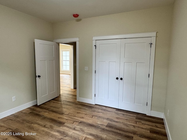 57 Malvern Ct, Brandenburg, KY 40108 - unfurnished bedroom featuring dark wood-type flooring and a closet