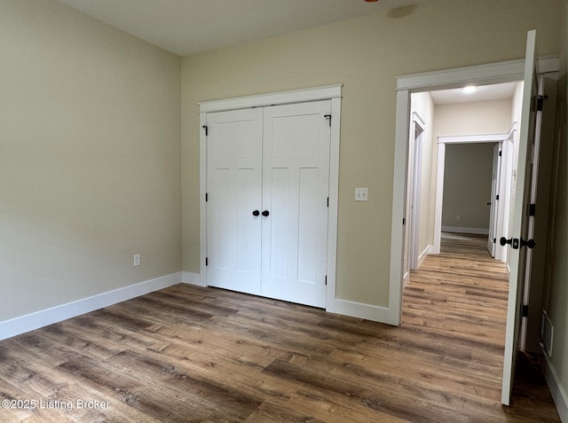 57 Malvern Ct, Brandenburg, KY 40108 - unfurnished bedroom with dark wood-type flooring and a closet