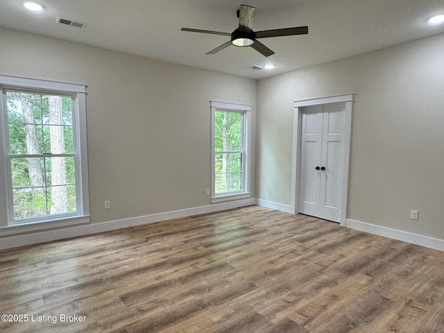 57 Malvern Ct, Brandenburg, KY 40108 - unfurnished bedroom featuring multiple windows, wood finished floors, recessed lighting, and ceiling fan
