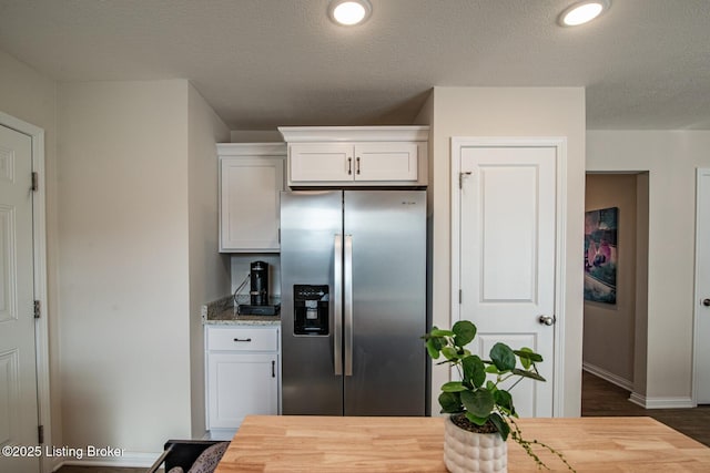 58 Sissy Ct, Elizabethtown, KY 42701 - kitchen with stainless steel fridge, white cabinets, baseboards, dark wood-style flooring, and wood counters