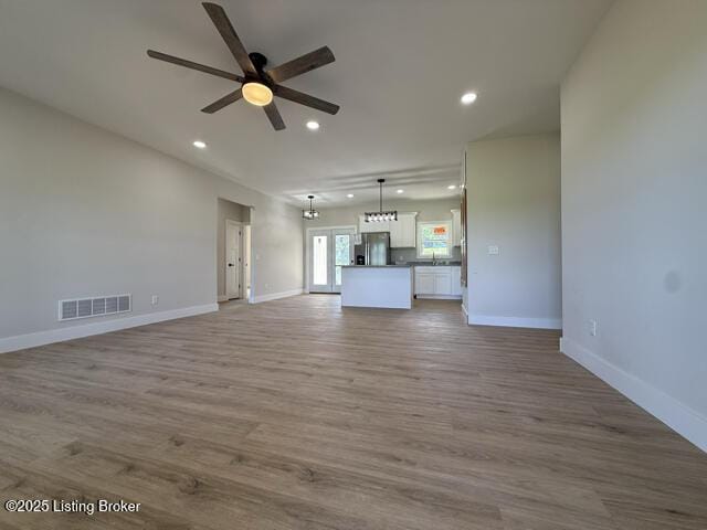 49 Roy Rd, Eastview, KY 42732 - unfurnished living room featuring a ceiling fan, recessed lighting, baseboards, and wood finished floors