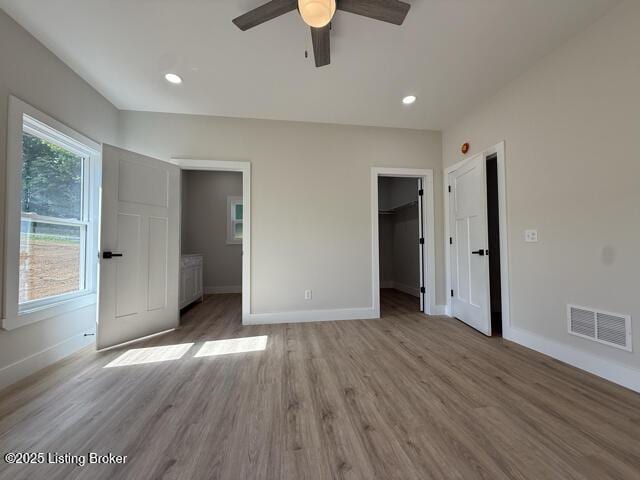 49 Roy Rd, Eastview, KY 42732 - unfurnished bedroom with baseboards, a walk in closet, light wood-style flooring, recessed lighting, and ceiling fan