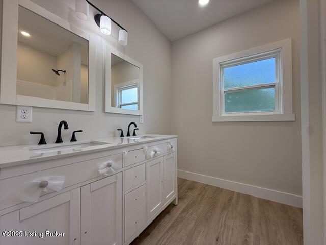 49 Roy Rd, Eastview, KY 42732 - full bathroom with wood finished floors, double vanity, and baseboards
