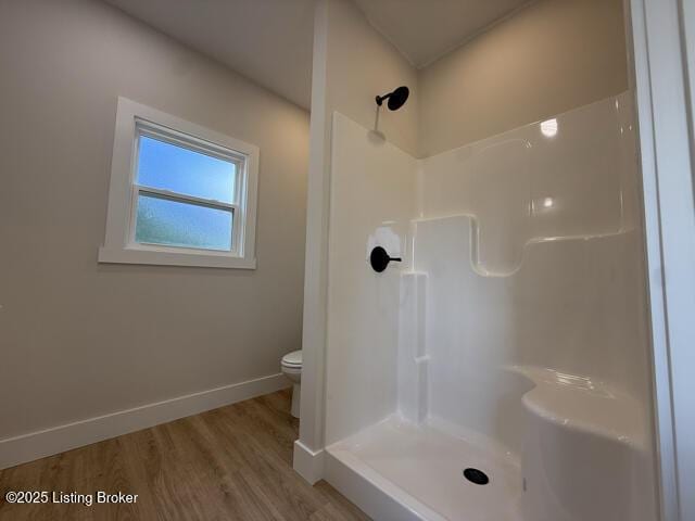 49 Roy Rd, Eastview, KY 42732 - bathroom featuring toilet, a shower, wood finished floors, and baseboards
