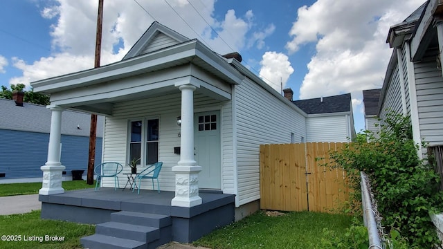 621 E Kentucky St, Louisville, KY 40203 - view of front of house with covered porch and a chimney