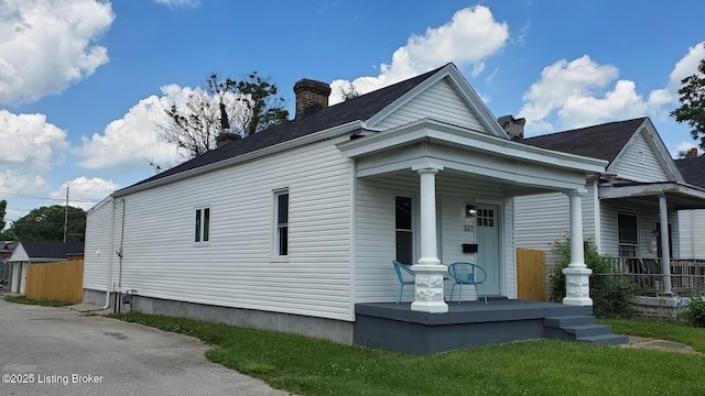621 E Kentucky St, Louisville, KY 40203 - view of front of house with covered porch and a chimney