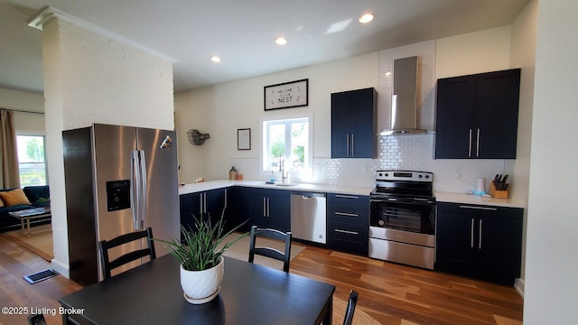 621 E Kentucky St, Louisville, KY 40203 - kitchen with stainless steel appliances, wall chimney range hood, dark cabinets, light countertops, and recessed lighting