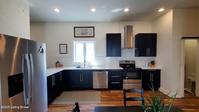 621 E Kentucky St, Louisville, KY 40203 - kitchen with appliances with stainless steel finishes, wall chimney range hood, a sink, light countertops, and light wood-style floors