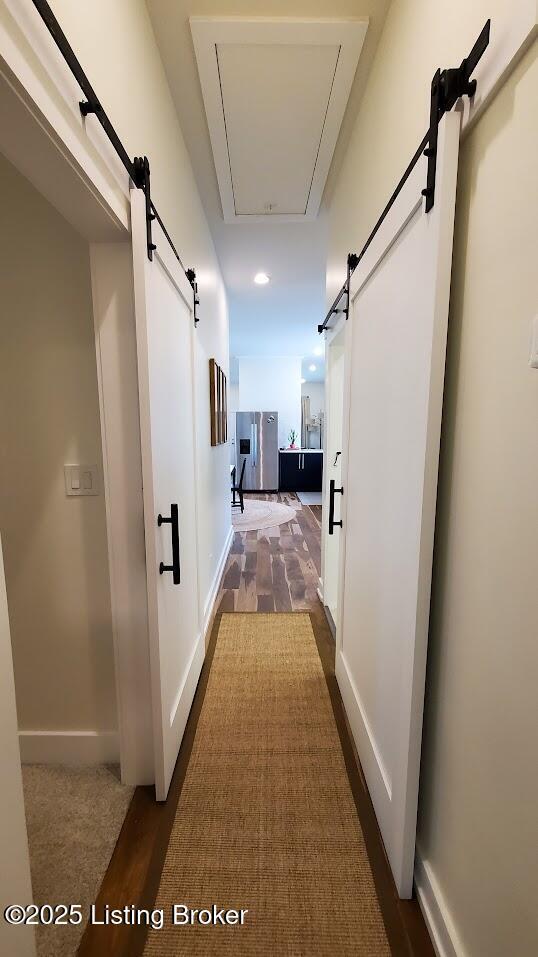 621 E Kentucky St, Louisville, KY 40203 - hall with a barn door, recessed lighting, baseboards, and attic access